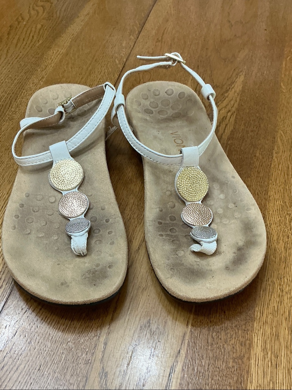 Woman’s Vionic white strap sandal. Size 9. Gently worn. Metal embellishments.